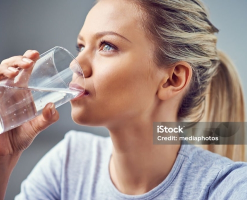 Young Woman Drinking Purified Water