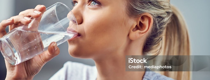 Young Woman Drinking Purified Water